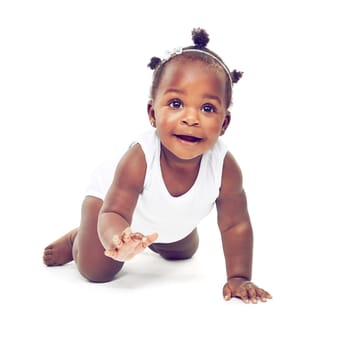 Studio shot of a baby girl crawling against a white background.