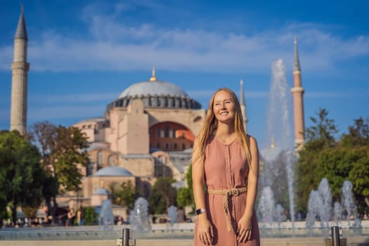 Woman enjoy beautiful view on Hagia Sophia Cathedral, famous islamic Landmark mosque, Travel to Istanbul, Turkey. Sunny day architecture and Hagia Sophia Museum, in Eminonu, istanbul, Turkey. Turkiye.