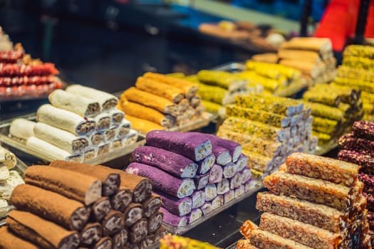 Traditional oriental sweet pastry cookies, nuts, dried fruits, pastilles, marmalade, Turkish desert with sugar, honey and pistachio, in display at a street food market.