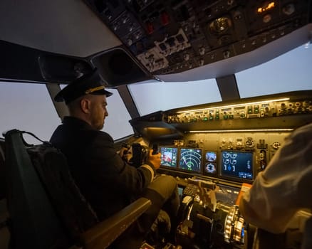 A man is studying to be a pilot in an aircraft simulator