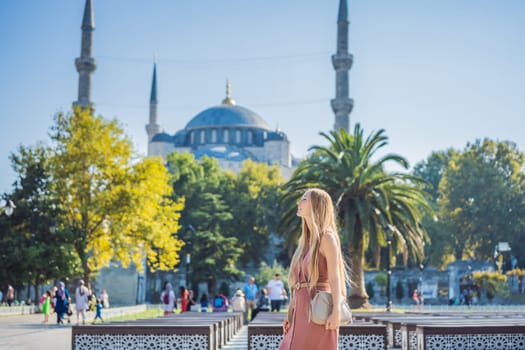 Woman tourist enjoying the view Blue Mosque Sultanahmet Camii Istanbul, Turkey.