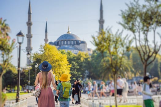 Mother and son tourists enjoying the view Blue Mosque Sultanahmet Camii Istanbul, Turkey. Traveling with kids concept.