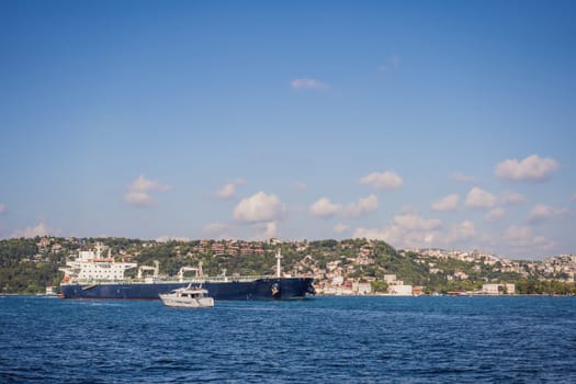 Fatih Sultan Mehmet Bridge Second bridge in Istanbul, Bosphorus with a magnificent looking cargo ship.