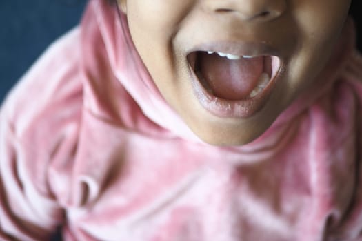 close up of child screaming at home , slow motion