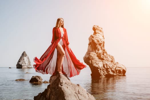 Woman travel sea. Happy tourist taking picture outdoors for memories. Woman traveler looks at the edge of the cliff on the sea bay of mountains, sharing travel adventure journey.