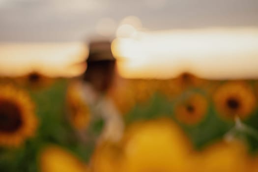 Woman in the sunflowers field. Summer time. Young beautiful woman standing in sunflower field.