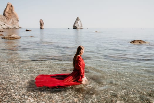 Woman travel sea. Happy tourist taking picture outdoors for memories. Woman traveler looks at the edge of the cliff on the sea bay of mountains, sharing travel adventure journey.