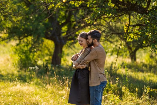 man hugging his girlfriend in nature