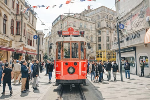 Istanbul, Turkey - May 02, 2023: Nostalgic traditional red tram in Beyoglu. The tram line runs along Istiklal Street (a popular place in Istanbul) between Taksim Square and the metro