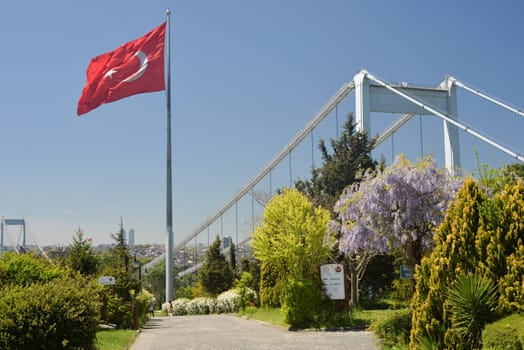 Istanbul, Turkey, May 02, 2023: View of Istanbul from Otagtepe with the Fatih Sultan Mehmet Bridge and flag waving in the wind. Travel Istanbul background photo