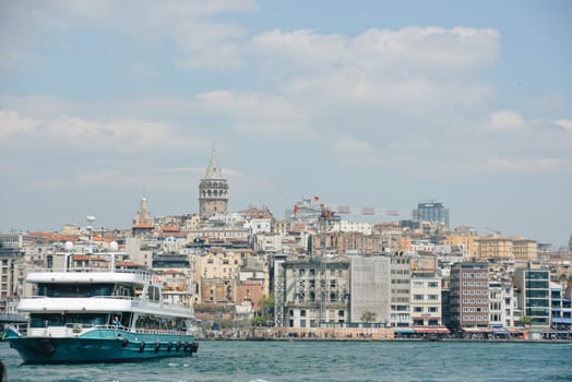 Istanbul, Turkey - May 02, 2023: Traveling along the Bosphorus on the passenger ferry Eminönü. View of the Galata bridge, Galata tower.
