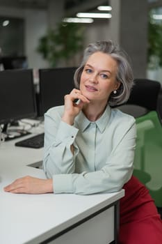 Mature caucasian woman at the desk in the office