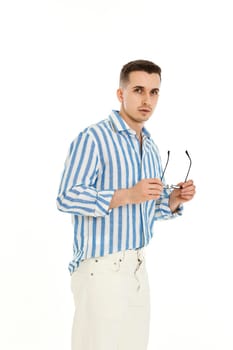 handsome young man in sunglasses and blue striped shirt isolated on white background. Summer fashion