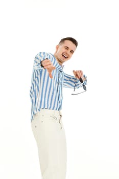 handsome young man in sunglasses and blue striped shirt pointing finger at you isolated on white background. Summer fashion