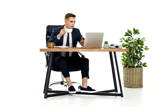 young friendly Freelancer man talking on video call to client, sitting on chair at desk, using laptop pc computer