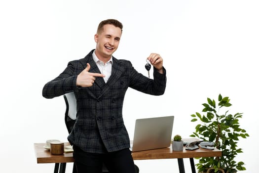 Successful caucasian businessman holding keys in the office. Car dealerships offer car . Car insurance. copy space