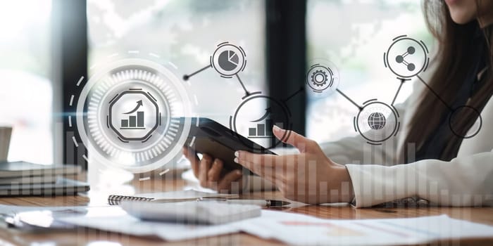 Business woman using tablet to analyze sales data and economic growth graph chart. technology and customer global network connection icon Business strategy.