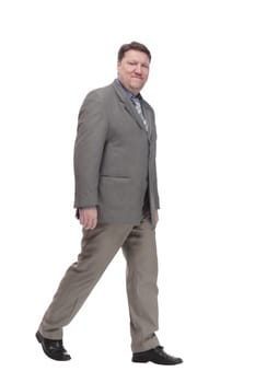 full-length. casual man in a grey jacket striding forward. isolated on a white background.