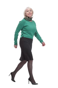in full growth. woman in a green jumper striding forward. isolated on a white background