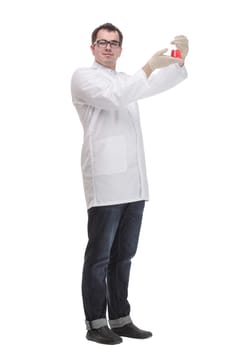 Confident man doctor wearing unifrom and glasses standing isolated over white background, holding beaker