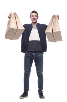 smiling young man with shopping bags . isolated on a white background.