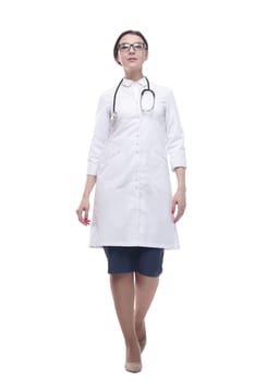 confident female doctor with a stethoscope striding forward. isolated on a white background.