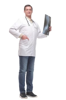 Attractive doctor examining an x-ray and looking at the camera seriously