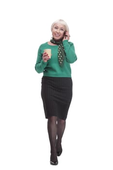 attractive woman with a smartphone and a takeaway coffee. isolated on a white background.