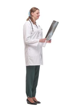 Front view of female doctor wearing stethoscope and glasses looking at an x-ray. Concept of medical help