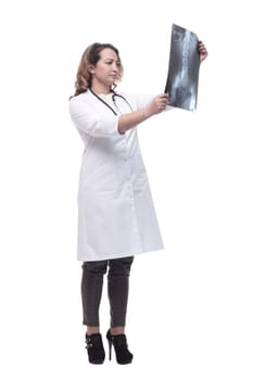 young female doctor looking at an x-ray. isolated on a white background.