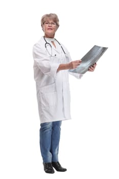 Front view of female doctor wearing stethoscope and glasses looking at an x-ray. Concept of medical help