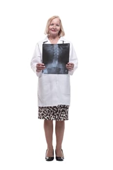 in full growth.female doctor looking at an x-ray. isolated on a white background.