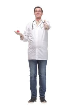 Cheerful male doctor or scientist in a white coat in gloves shows thumb up and holding the beaker