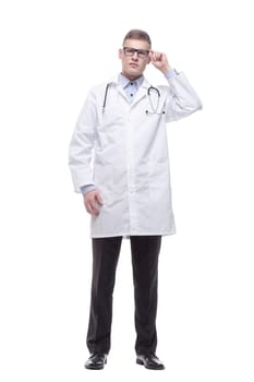 in full growth. confident young doctor with a stethoscope. isolated on a white background.