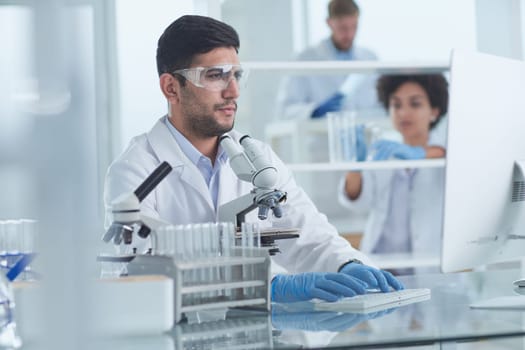 Focused male scientist working in laboratory