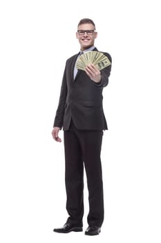 in full growth. happy young businessman with cash banknotes. isolated on a white background.