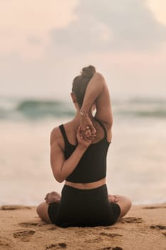 Beautiful girl doing yoga at the beach. High quality photo