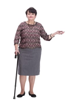 full-length. casual elderly woman with a walking stick. isolated on a white background.
