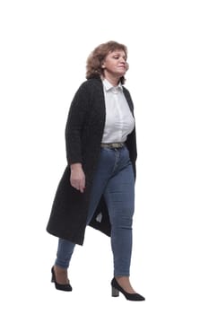 in full growth. confident mature woman taking a step forward. isolated on a white background