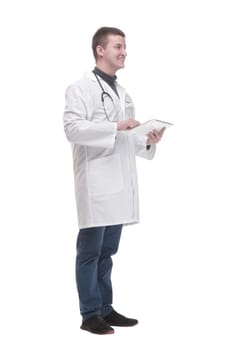in full growth. modern doctor with a digital tablet. isolated on a white background.