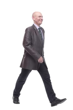 in full growth. Executive business man striding forward . isolated on a white background.