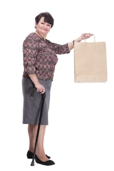 casual elderly woman with a walking stick and shopping bags. isolated on a white background.