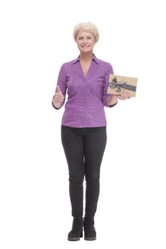in full growth. happy mature woman with gift box. isolated on a white background.