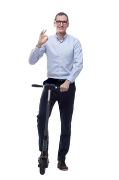 in full growth. casual man with electric scooter showing OK gesture. isolated on white