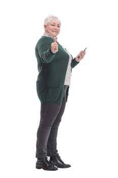 Side view of happy modern middle age woman wearing jeans with smart phone. Full body length isolated on white background.
