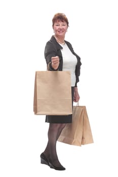 Side view portrait of happy senior woman posing with her shopping bag looking at camera and smiling