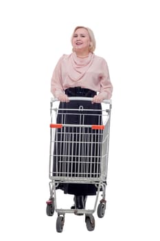 standing young woman with empty shopping cart smiling at camera
