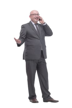 in full growth. business man with a smartphone.isolated on a white background.