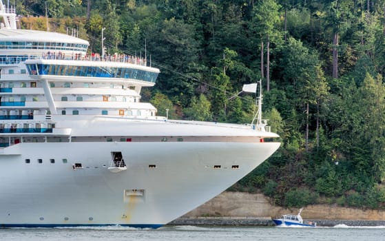 Huge white cruise liner passing by Stenley Park in Vancouver, Canada.