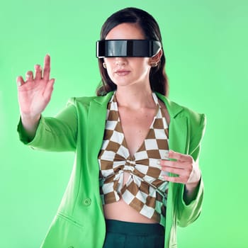 Woman, vr and glasses in studio with hand by green background, gaming or web design for iot. Gen z model, education or idea for virtual reality coding, creative or fashion for ui, focus or metaverse.